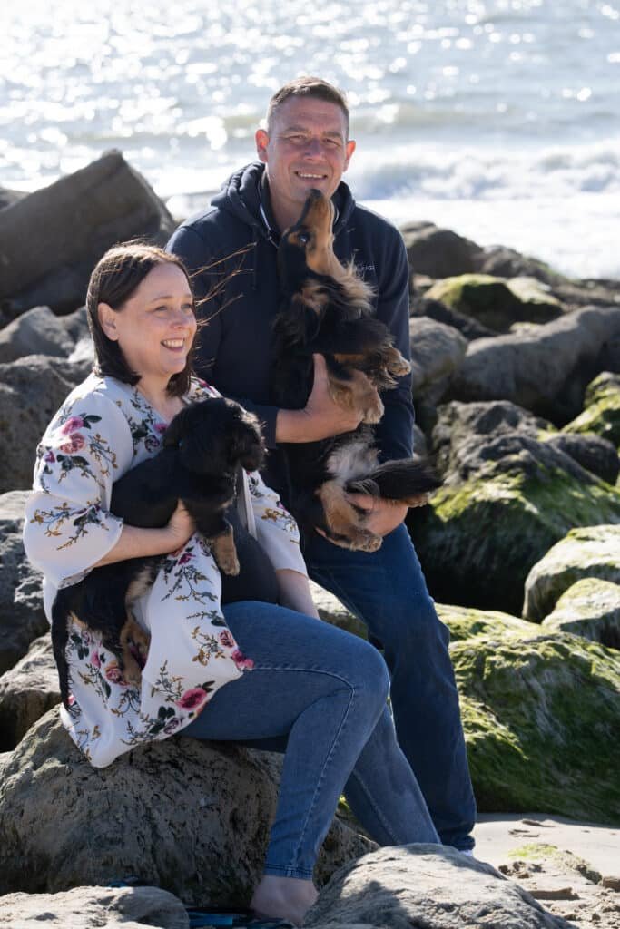 sharon and jason on the beach with their dogs