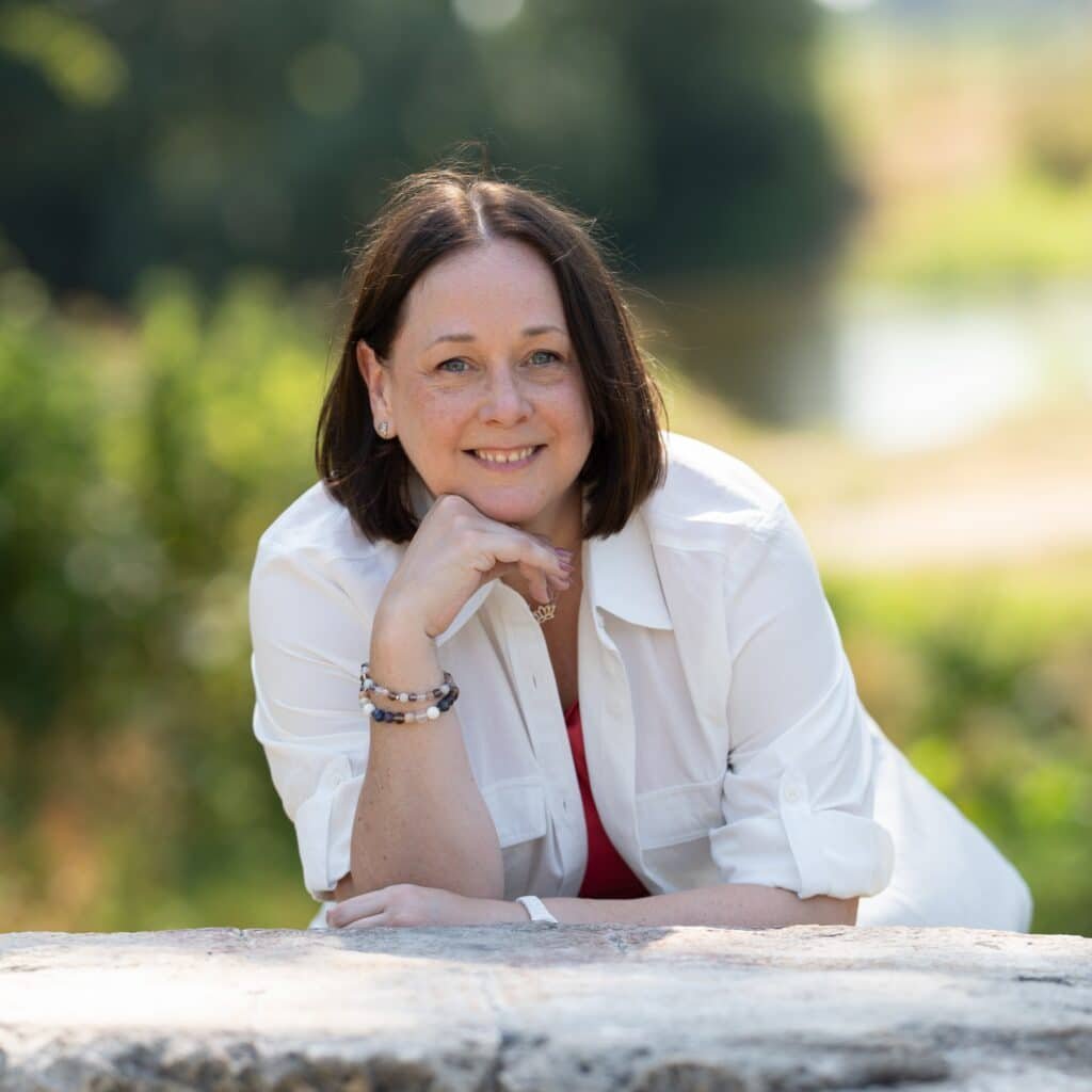 close up image of sharon leaning on a rock