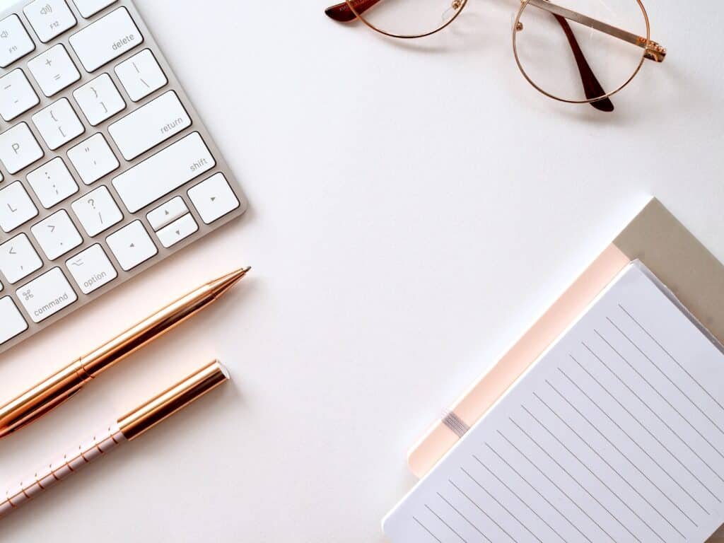 flatlay image of a keyboard and notepad